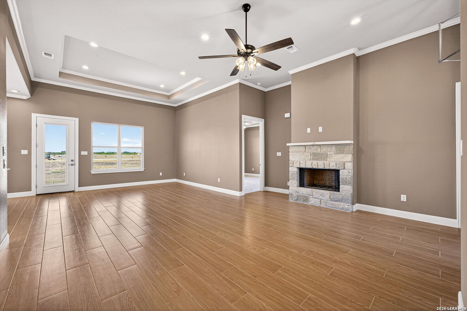 123 John T Court Castroville, TX 78009 - Photo 9 of 45 a view of an empty room with window and wooden floor