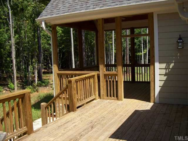 7208 Duncans Ridge Way Fuquay-Varina, NC 27526 - Photo 10 of 12 View of the deck and the screened porch. Picture quiet times for relaxation, overlooking your wooded back yard. There is also a concrete patio nearby for your grill! Screened Porch