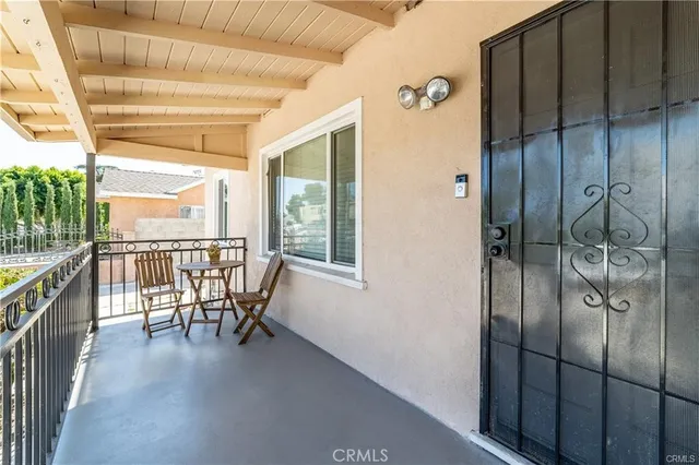 a view of a hallway with furniture and floor to ceiling window