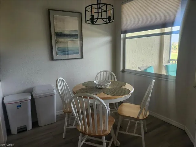 a view of a dining room with furniture and window