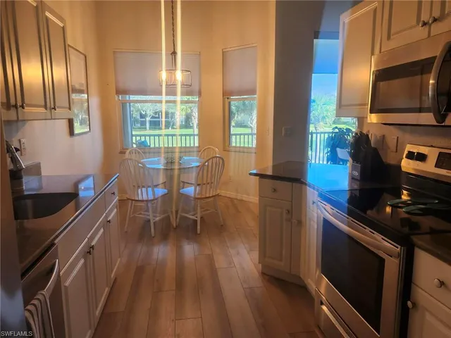 a kitchen with stainless steel appliances a stove top oven a sink and cabinets