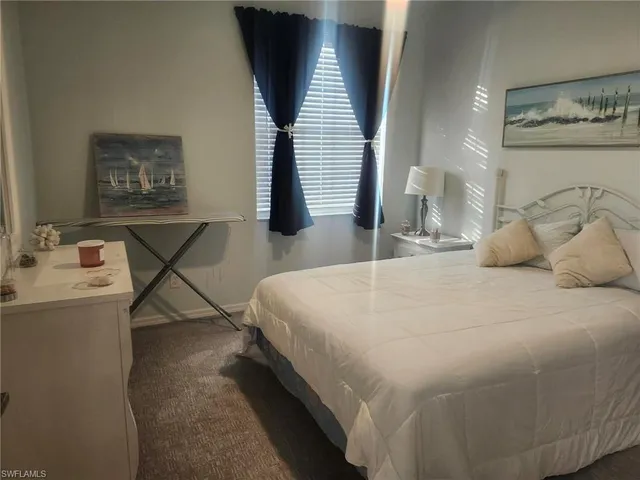 a bedroom with a bed and a night stand