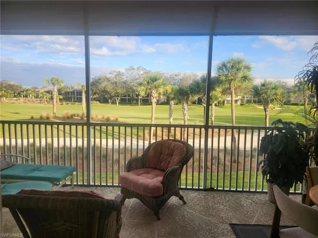 a view of a chair and tables in the balcony