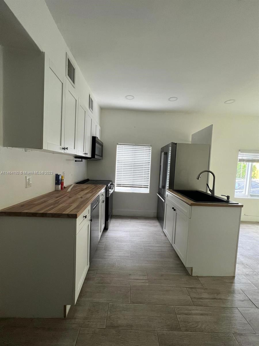 Santa Clara Miami, FL 33127 - Photo 2 of 14 a large kitchen with stainless steel appliances granite countertop a large counter top and a stove