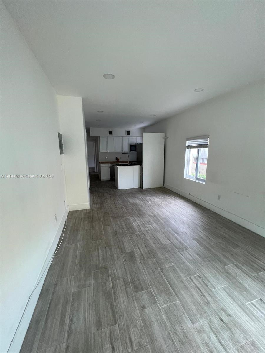 Santa Clara Miami, FL 33127 - Photo 5 of 14 a view of a big room with wooden floor and windows