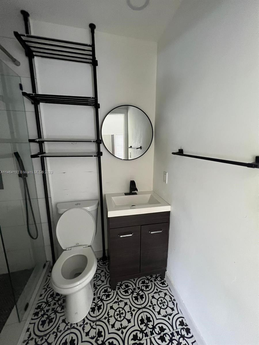 Santa Clara Miami, FL 33127 - Photo 8 of 14 a bathroom with a toilet a sink and mirror