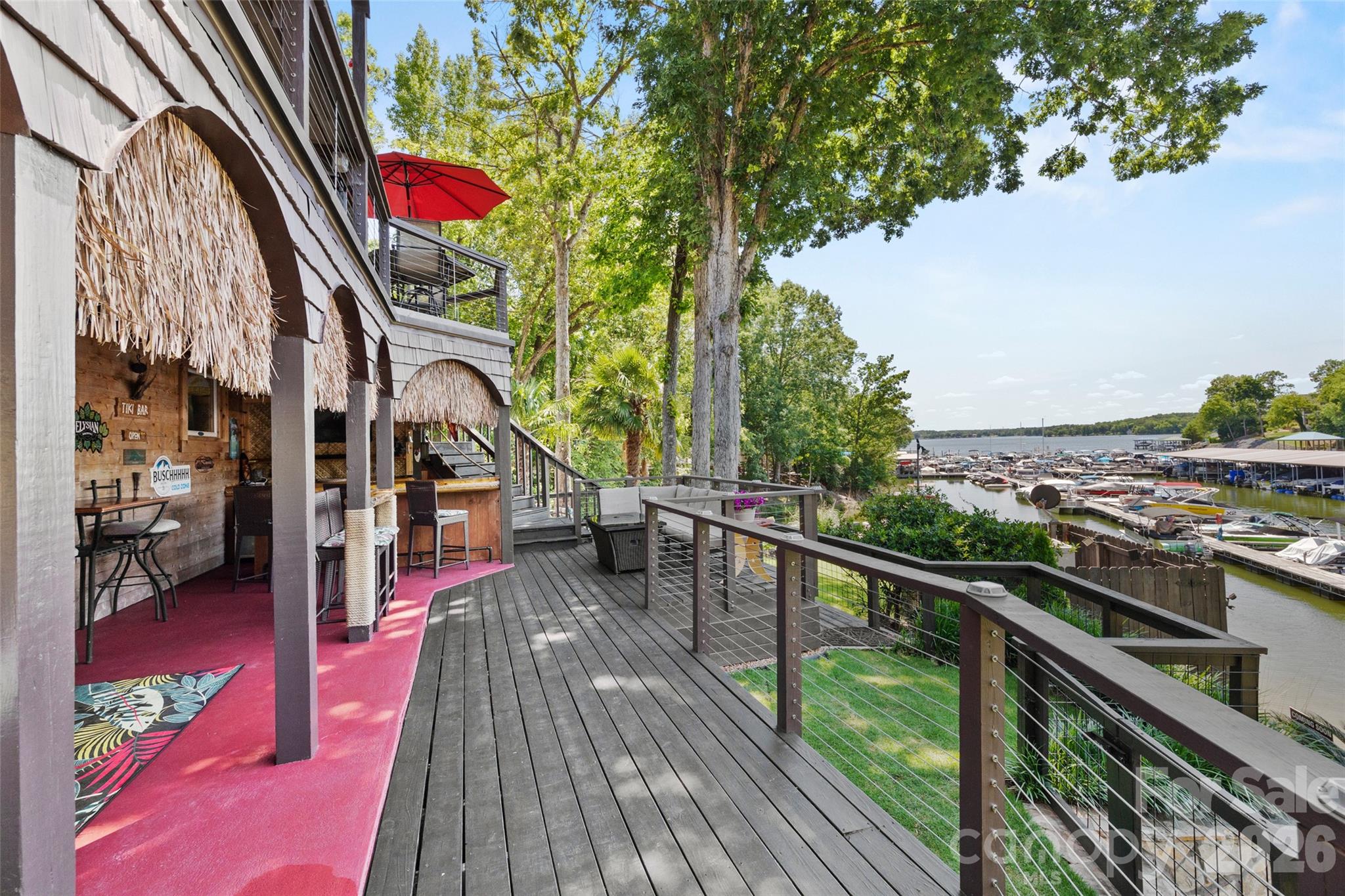 27056 Catamaran Drive Tega Cay, SC 29708 - Photo 16 of 48 a view of a balcony with wooden floor and outdoor seating