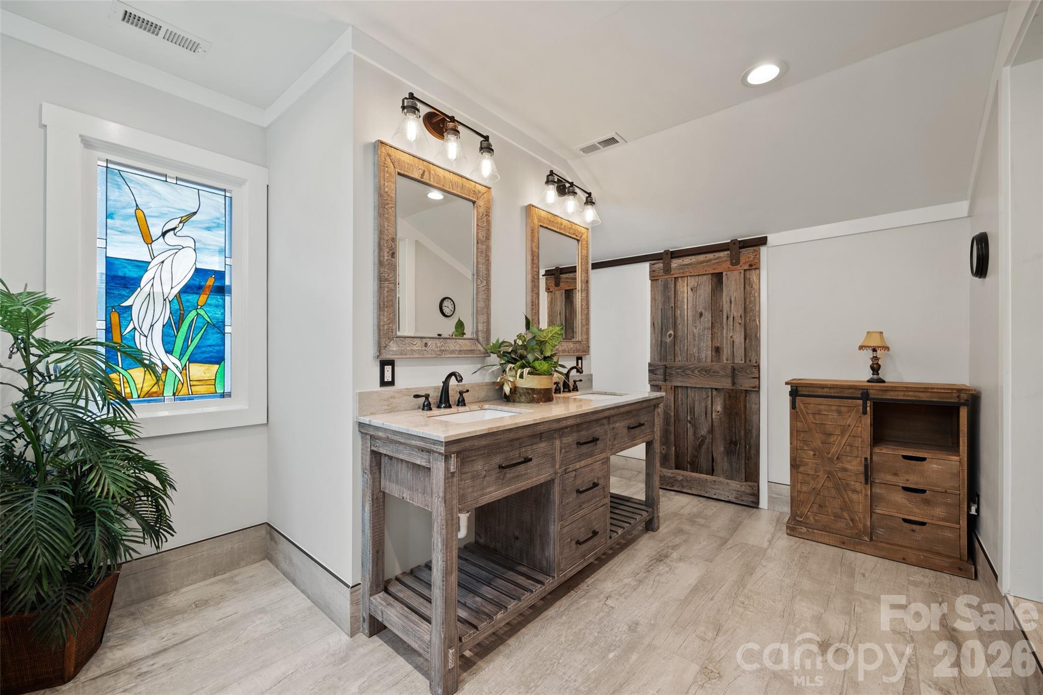 27056 Catamaran Drive Tega Cay, SC 29708 - Photo 25 of 48 a spacious bathroom with a double vanity sink and a mirror