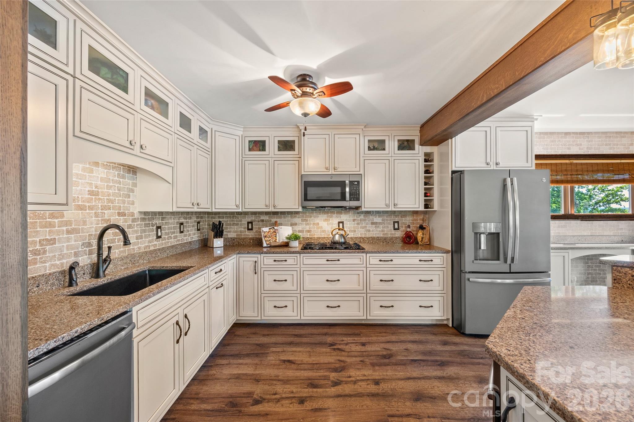27056 Catamaran Drive Tega Cay, SC 29708 - Photo 7 of 48 a kitchen with stainless steel appliances granite countertop a sink a stove and refrigerator