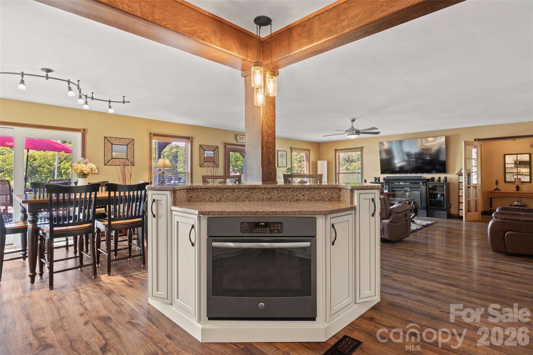 27056 Catamaran Drive Tega Cay, SC 29708 - Photo 9 of 48 a open kitchen with stainless steel appliances granite countertop a stove and cabinets with wooden floor