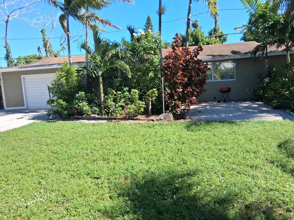 3832 Elizabeth Street Palm Springs, FL 33461 - Photo 1 of 1 a view of a house with a yard and potted plants