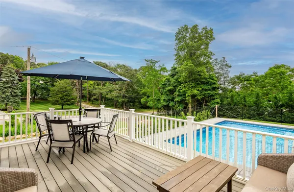 a view of a chairs and table on the deck