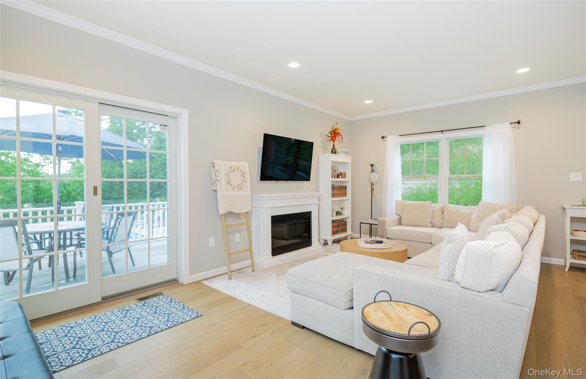 15 South Beach Road Southampton, NY 11968 - Photo 13 of 28 a living room with furniture and a fireplace