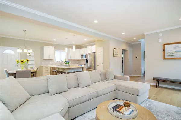 a living room with furniture kitchen and a table
