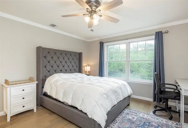 a bedroom with a large bed and a window