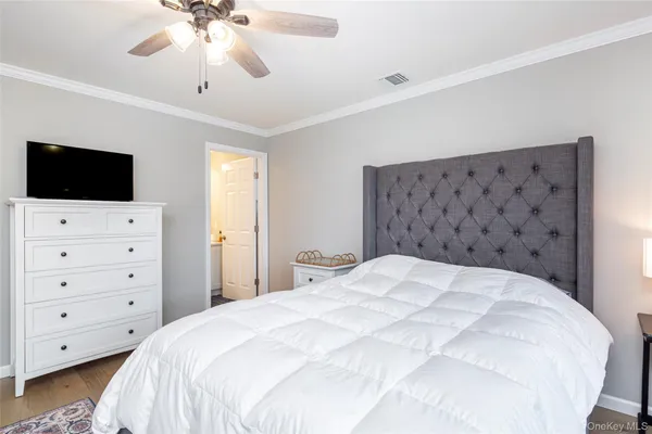 a large white bed in a bedroom