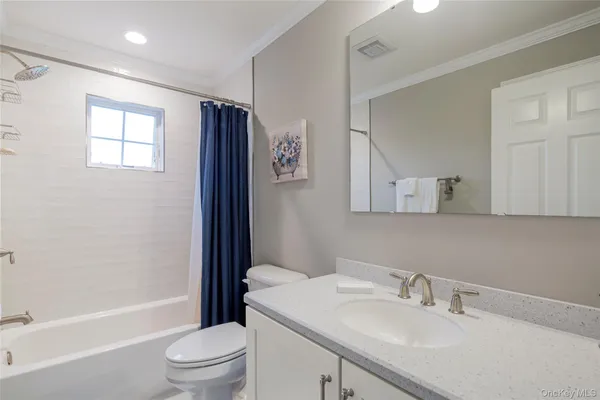 a bathroom with a sink toilet a mirror and shower