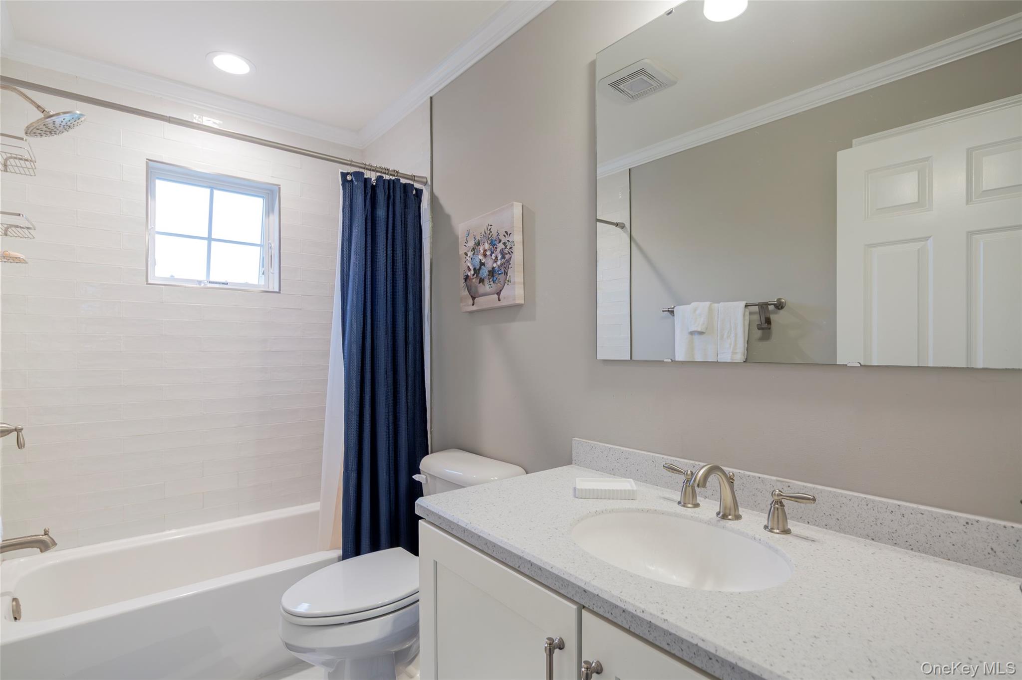 15 South Beach Road Southampton, NY 11968 - Photo 25 of 28 a bathroom with a sink toilet a mirror and shower