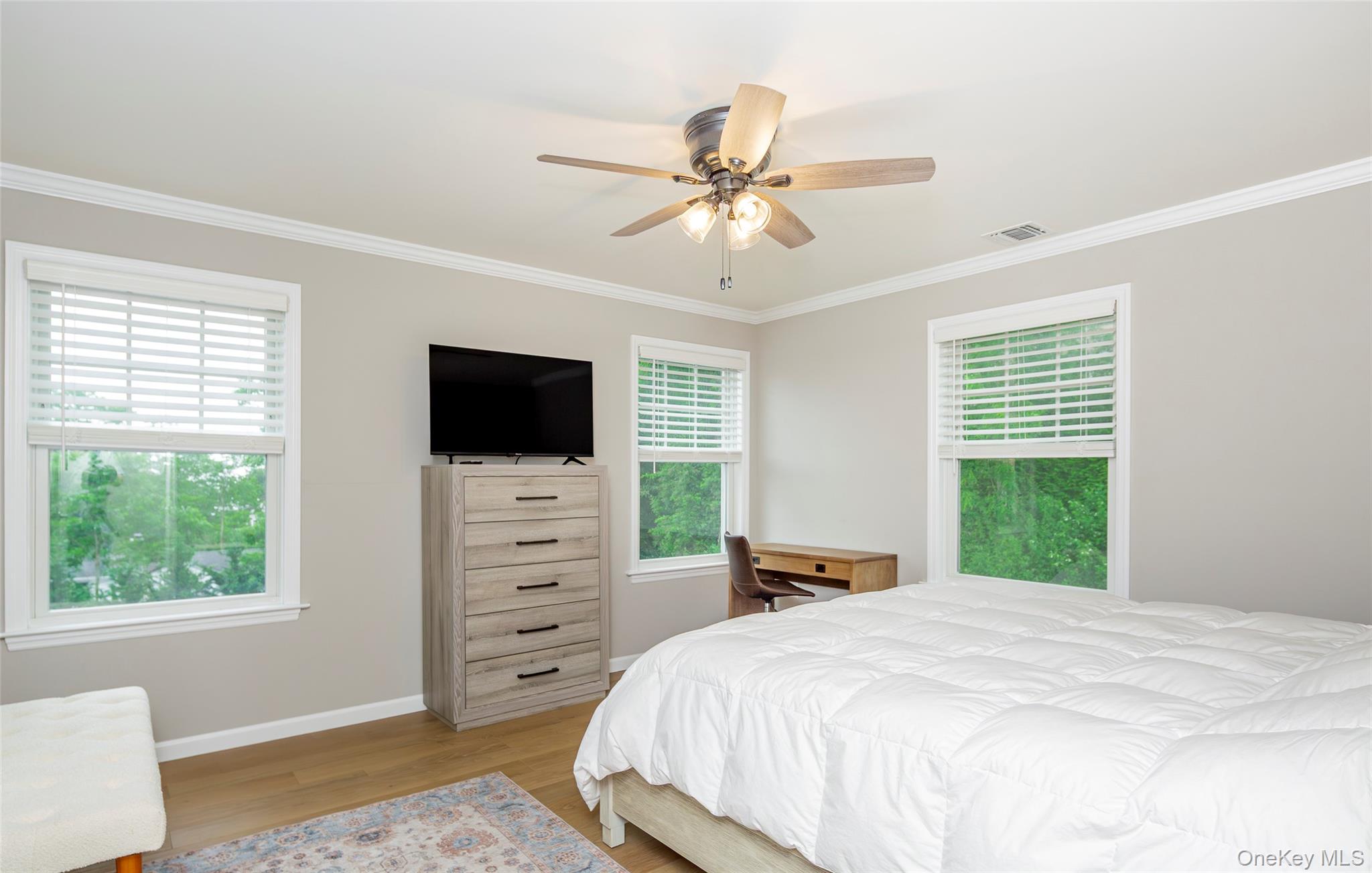 15 South Beach Road Southampton, NY 11968 - Photo 27 of 28 a bedroom with a bed and a flat screen tv