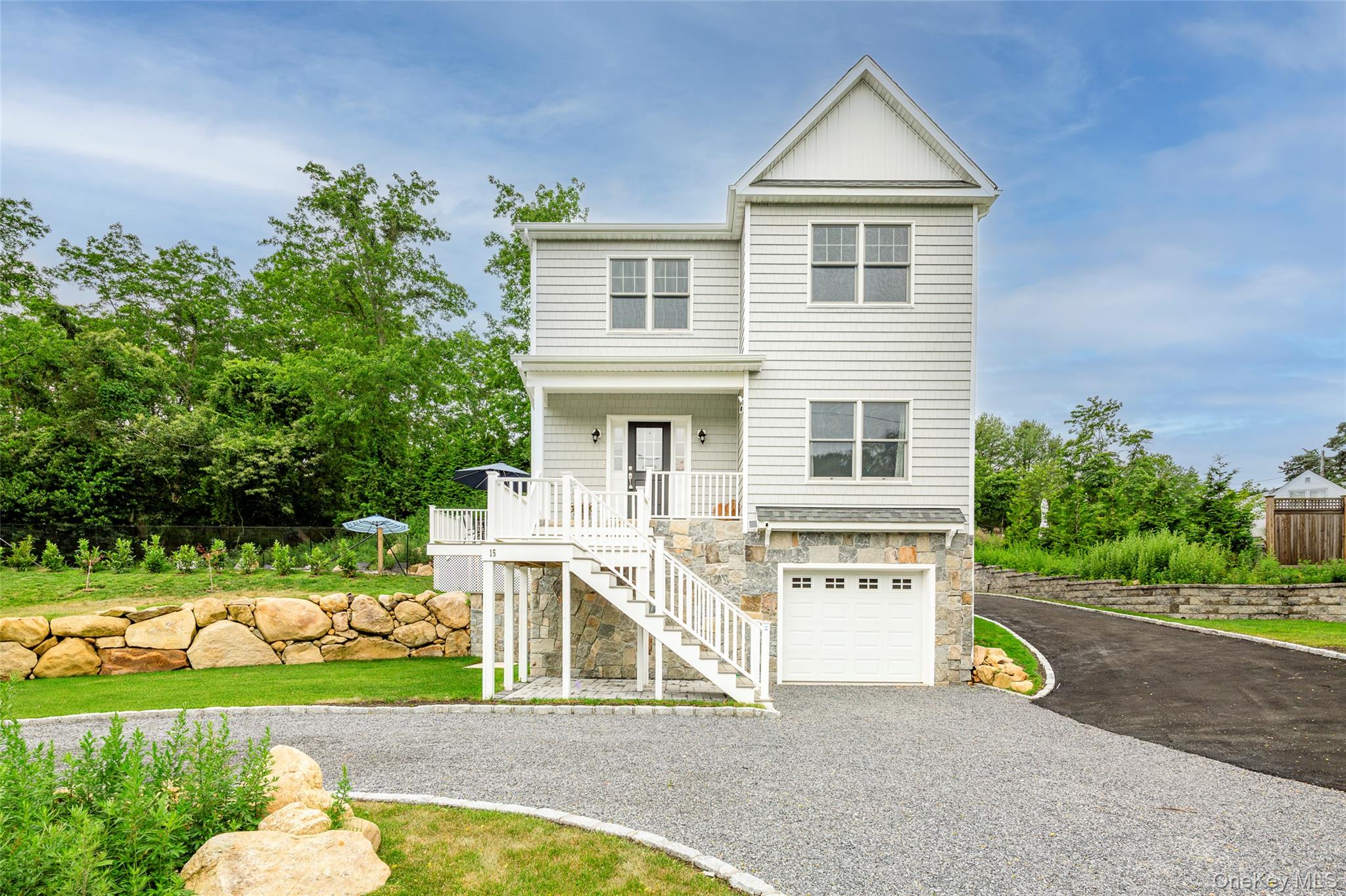 15 South Beach Road Southampton, NY 11968 - Photo 6 of 28 a view of house with outdoor street and trees in the background