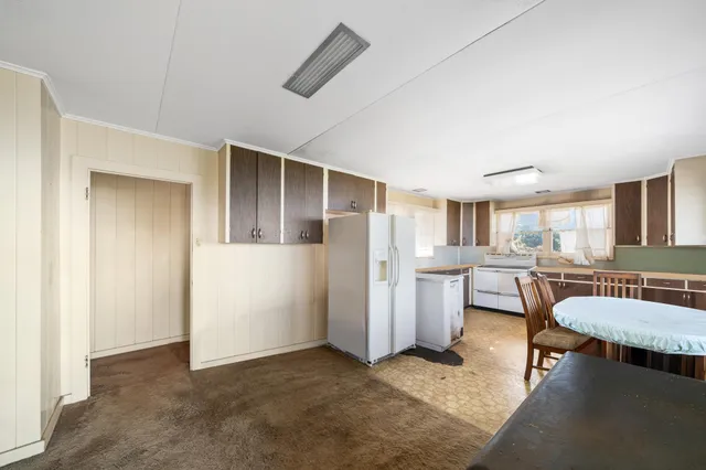 a living room with furniture and a kitchen