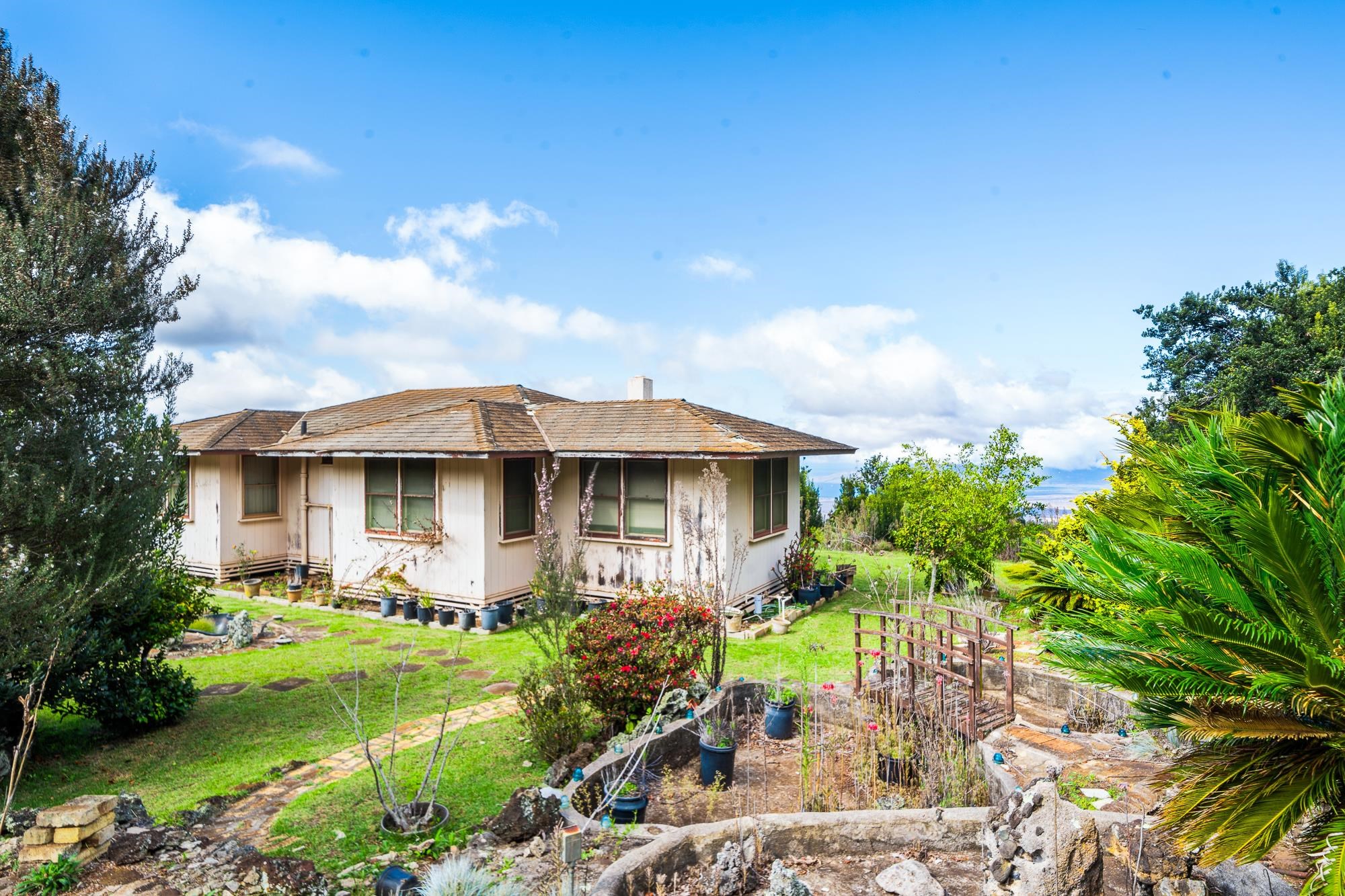 1375 Copp Road Kula, HI 96790 - Photo 27 of 35 a front view of a house with garden