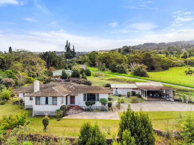 a aerial view of a house with swimming pool garden and lake view