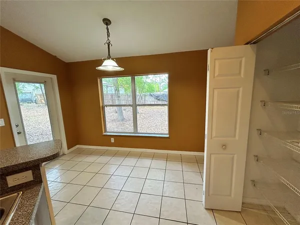 a view of an entryway with window and chandelier fan