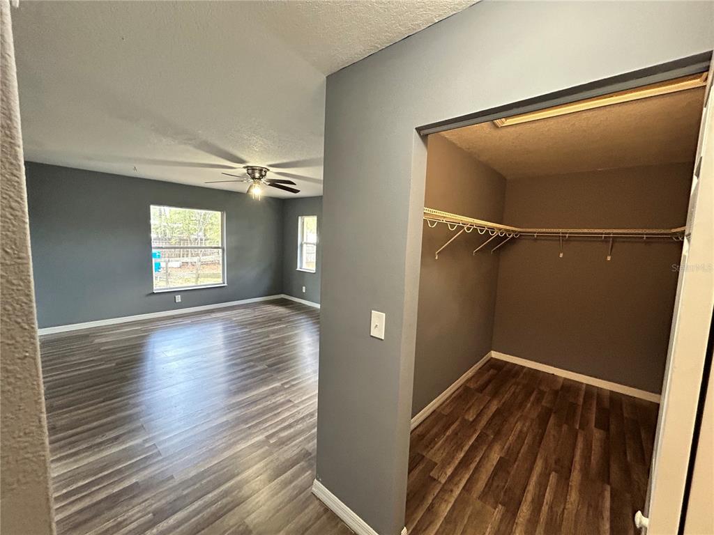 4475 Southwest 115th Street Ocala, FL 34476 - Photo 16 of 35 a view of an empty room with wooden floor and a window