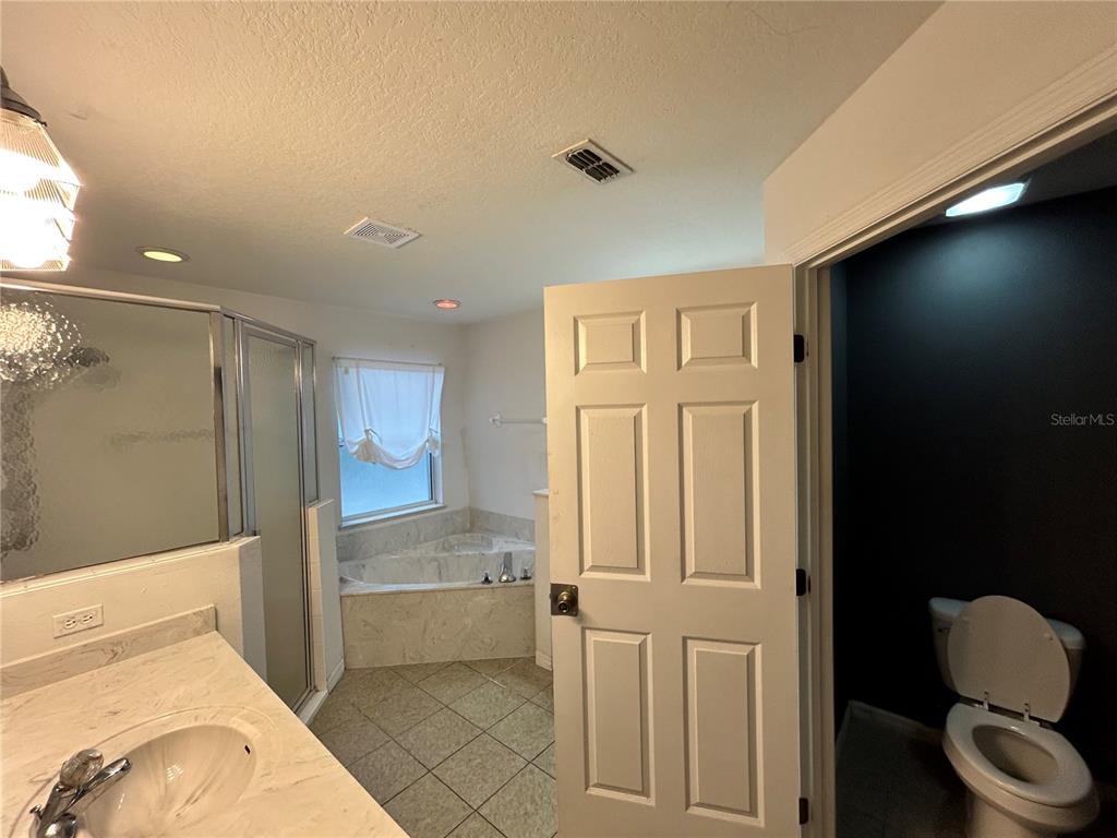 4475 Southwest 115th Street Ocala, FL 34476 - Photo 18 of 35 a bathroom with a toilet and a bathtub