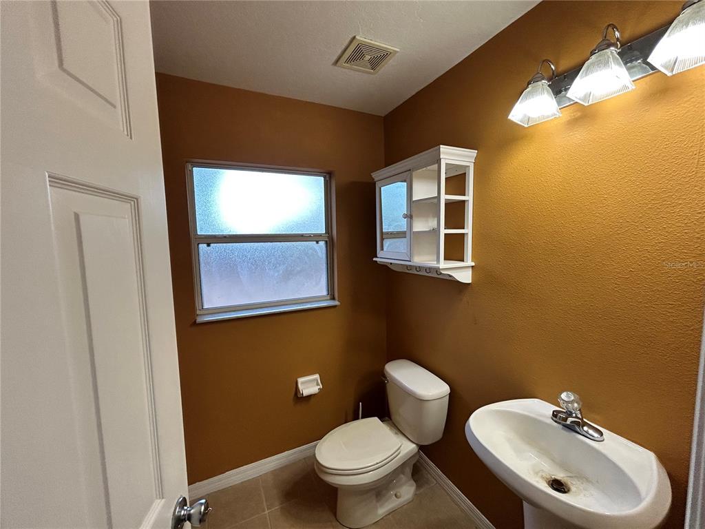 4475 Southwest 115th Street Ocala, FL 34476 - Photo 19 of 35 a bathroom with a toilet sink and mirror