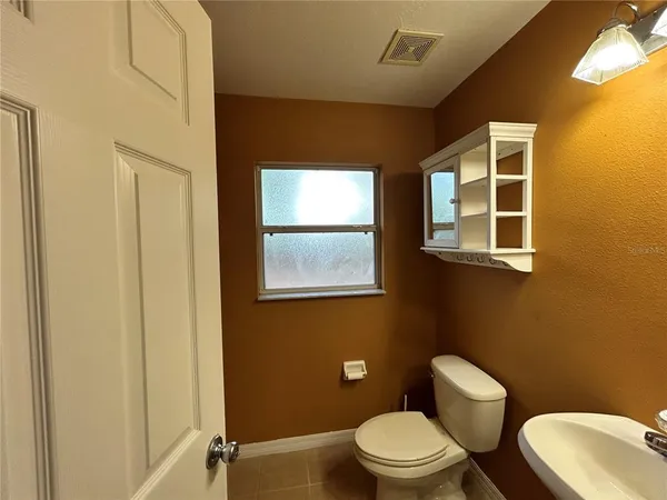 a white toilet sitting next to a bathroom sink