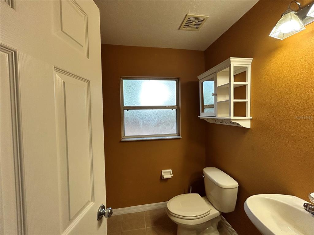 4475 Southwest 115th Street Ocala, FL 34476 - Photo 20 of 35 a white toilet sitting next to a bathroom sink