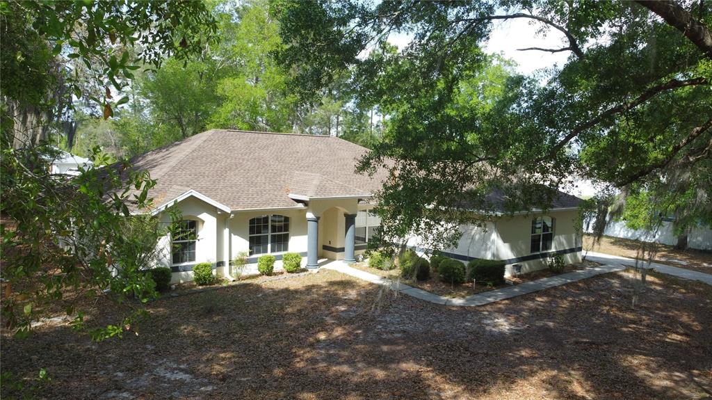 4475 Southwest 115th Street Ocala, FL 34476 - Photo 2 of 35 a view of a house with a yard