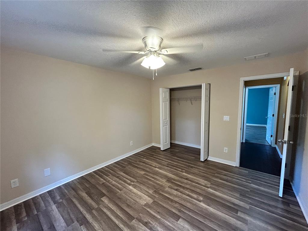 4475 Southwest 115th Street Ocala, FL 34476 - Photo 23 of 35 wooden floor in an empty room with a fan