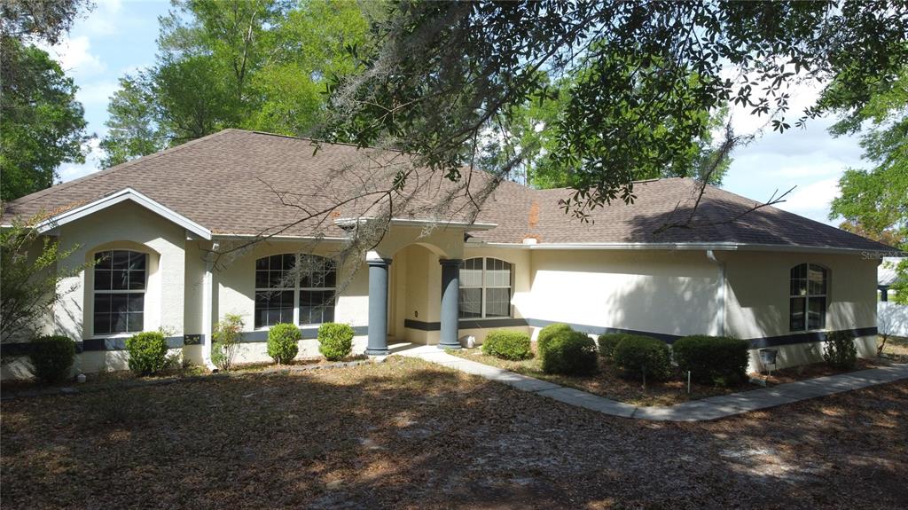 4475 Southwest 115th Street Ocala, FL 34476 - Photo 27 of 35 a front view of a house with a yard and garage