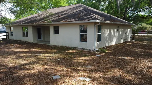 a front view of house with yard and trees