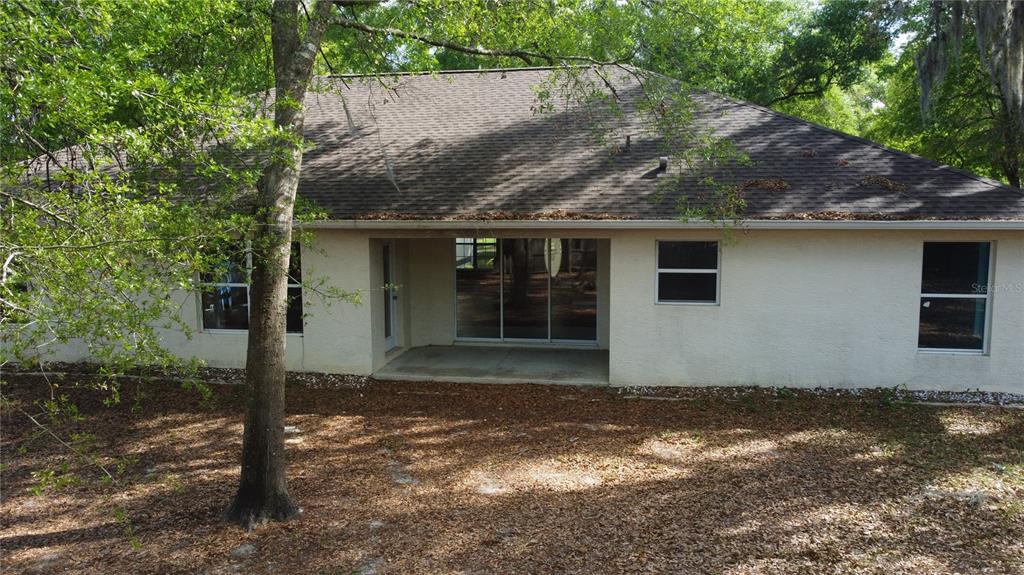 4475 Southwest 115th Street Ocala, FL 34476 - Photo 30 of 35 a house with a tree in front of it