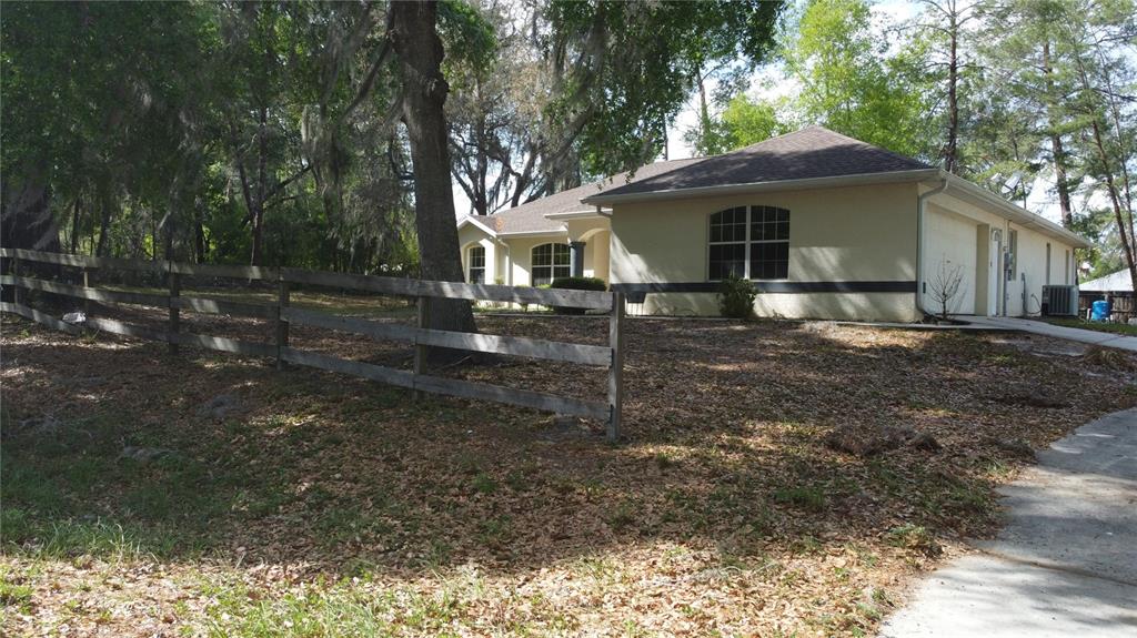 4475 Southwest 115th Street Ocala, FL 34476 - Photo 4 of 35 a front view of a house with a yard