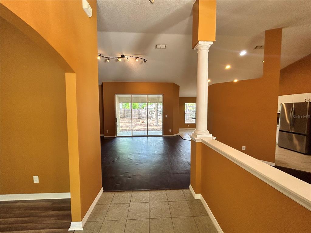 4475 Southwest 115th Street Ocala, FL 34476 - Photo 5 of 35 a view of a hallway with wooden floor and a living room