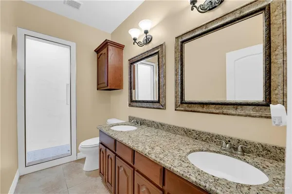 a bathroom with 2 sink and a mirror