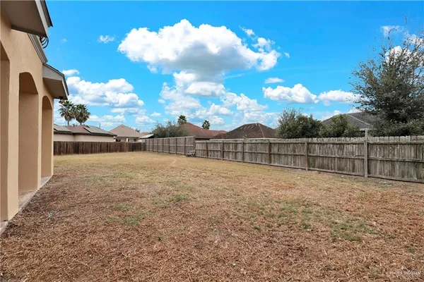 a view of backyard with trampoline
