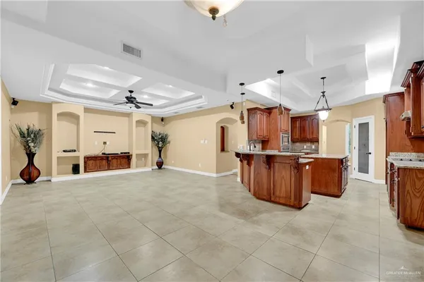 a view of a kitchen with furniture and a refrigerator
