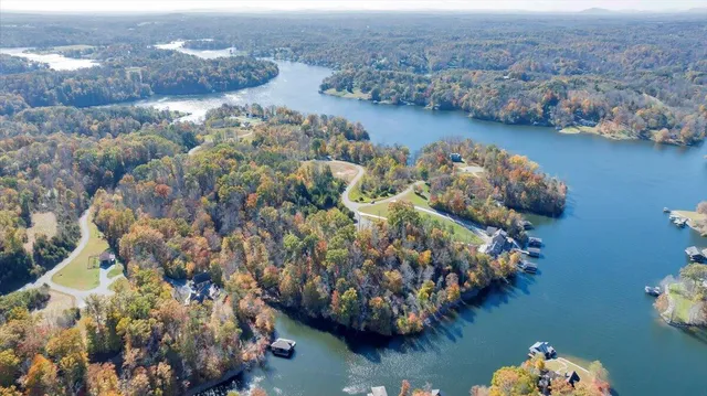 an aerial view of lake and residential houses with outdoor space