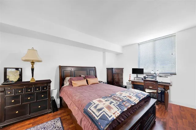 a bed room with a bed and a television