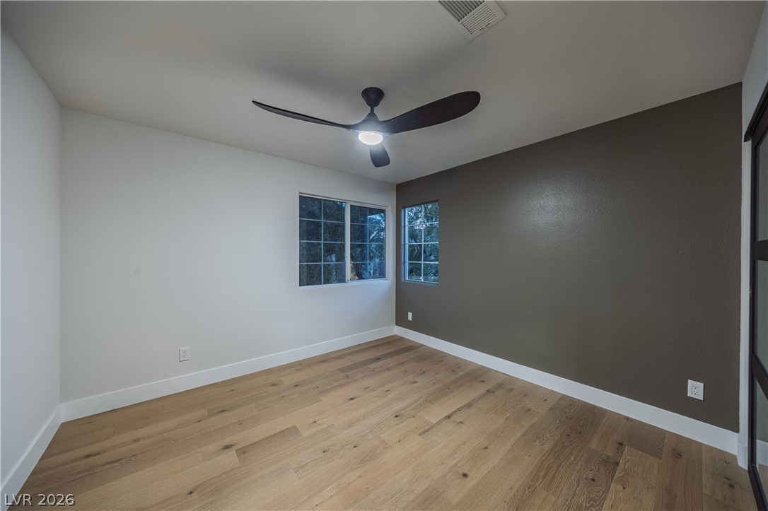 8800 Lusso Las Vegas, NV 89134 - Photo 72 of 85 Empty room with light wood-style floors and a ceiling fan