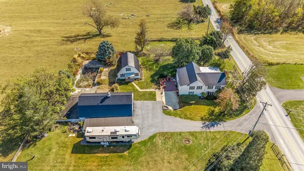 a aerial view of a house with swimming pool and large trees