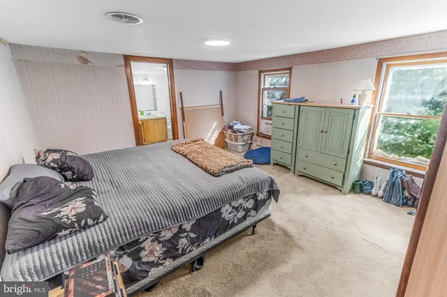 a bedroom with a bed and a window