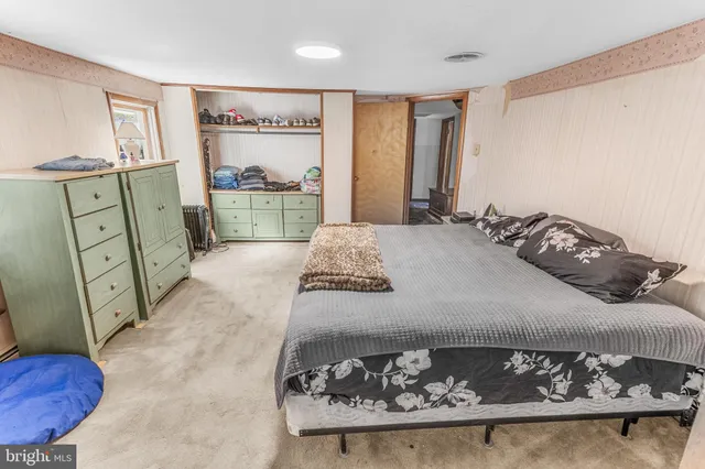 a bedroom with a bed and a mirror