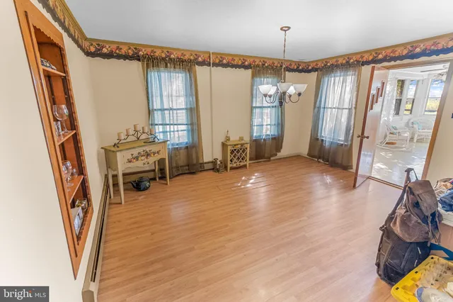 a view of a livingroom with furniture window wooden floor and staircase